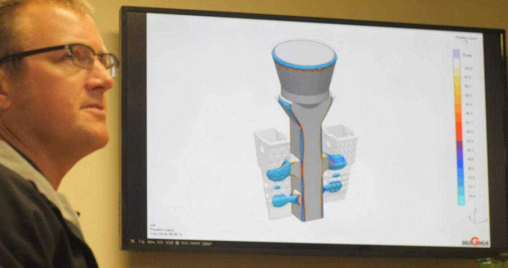 Presentor discussing a design of a part on screen